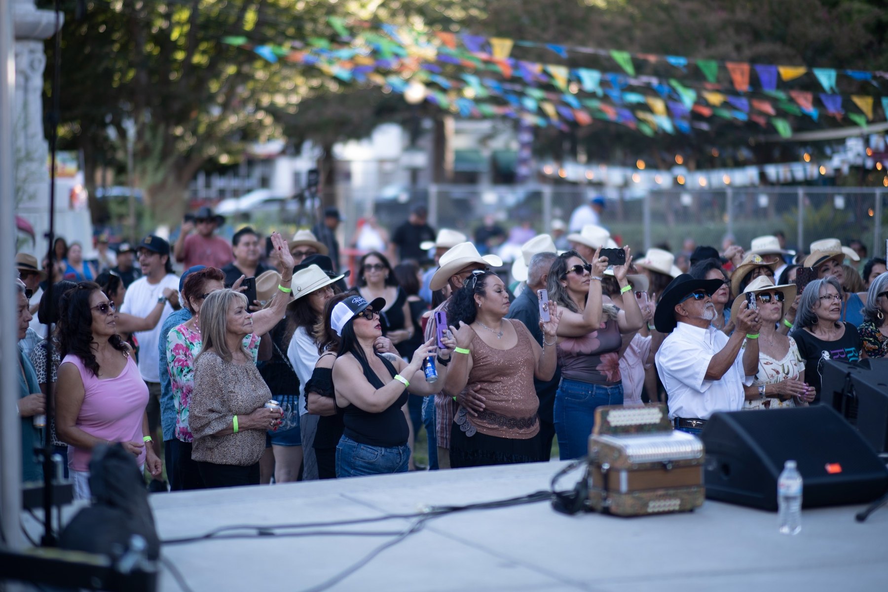 Audience members watching and recording the Tejano Conjunto Festival performance in Sacramento